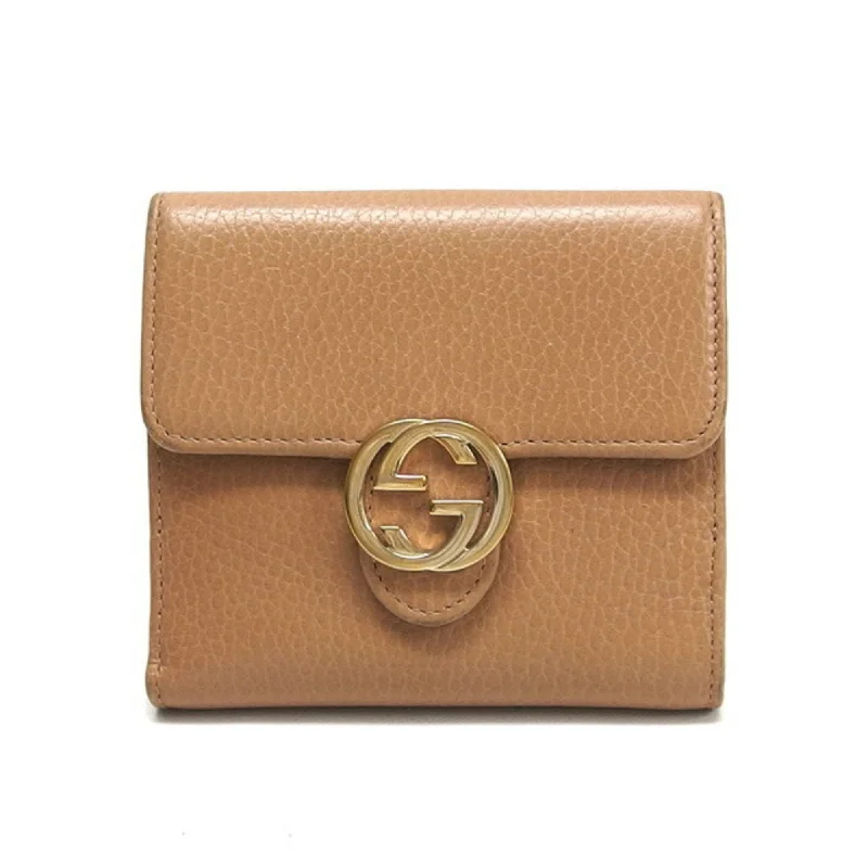 Women Gucci bags with a zip - around closure for securityGucci interlocking G bi-fold wallet beige